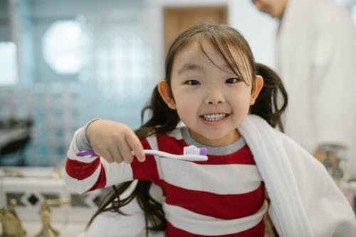 kid-on-toothbrush.jpeg